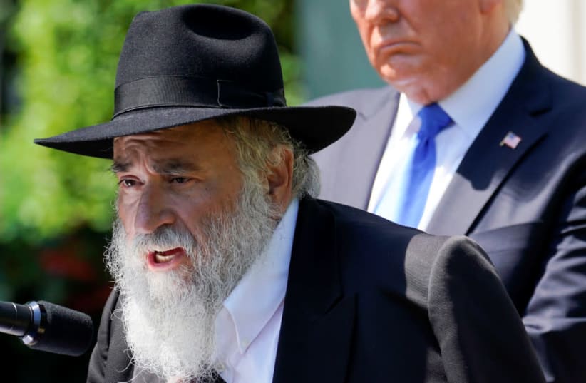 Rabbi Yisroel Goldstein, injured in the recent shooting at the Congregation Chabad synagogue in Poway, California, speaks as U.S. President Donald Trump looks on during the "National Day of Prayer" Service in the Rose Garden at the White House in Washington (photo credit: KEVIN LAMARQUE/REUTERS)