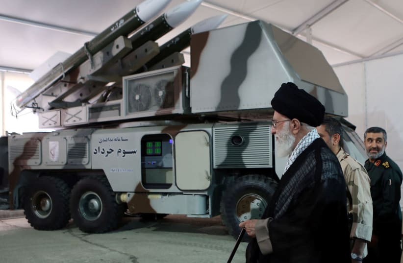 Iran's Supreme Leader Ayatollah Ali Khamenei is seen near a "3 Khordad" system which is said to had been used to shoot down a U.S. military drone, according to news agency Fars, in this undated handout picture (photo credit: FARS NEWS/HANDOUT VIA REUTERS)