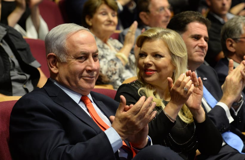 Prime Minister Benjamin Netanyahu and his wife, Sara Netanyahu, at the Jerusalem Theater (photo credit: CHAIM TZACH/GPO)