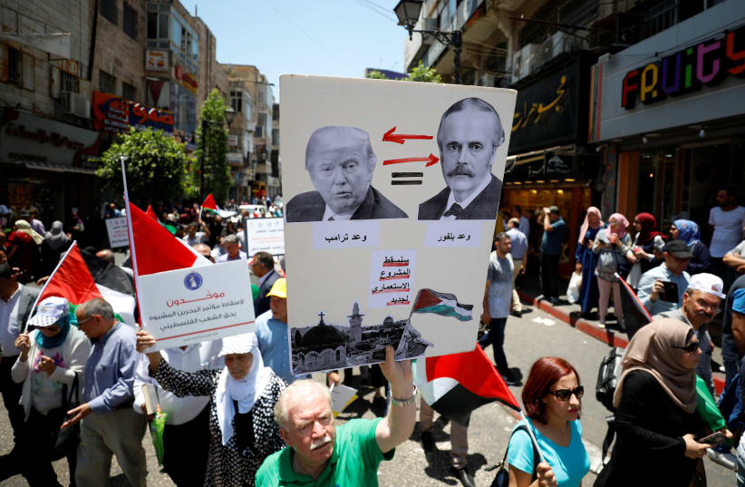 Palestinians take part in a protest against Bahrain's workshop for U.S. peace plan, in Ramallah, in the West Bank (photo credit: MOHAMAD TOROKMAN/REUTERS)