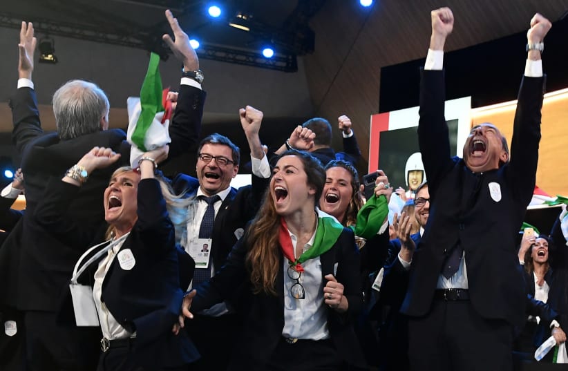 Mayor of Milan Giuseppe Sala and delegation members representing Milano and Cortina celebrate after the cities won the bid to host the 2026 Winter Olympic Games during the 134th Session of the International Olympic Committee (IOC), at the SwissTech Convention Centre, in Lausanne, Switzerland June 24 (photo credit: PHILIPPE LOPEZ/POOL VIA REUTERS)