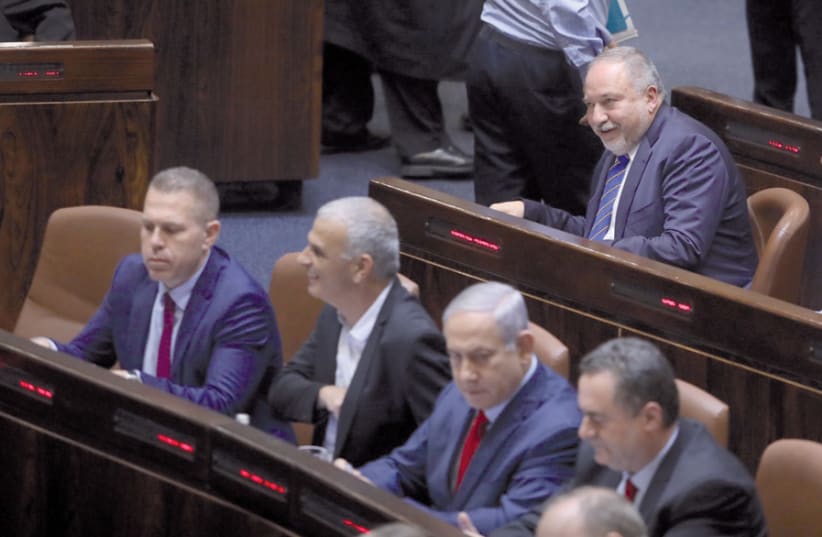 Avigdor Liberman sits behind Prime Minister Benjamin Netanyahu on May 29, when the Knesset decided to call new elections on September 17 (photo credit: MARC ISRAEL SELLEM)