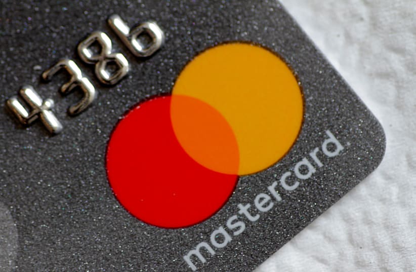 Illustration photo of a Mastercard logo on a credit card (photo credit: THOMAS WHITE / REUTERS)