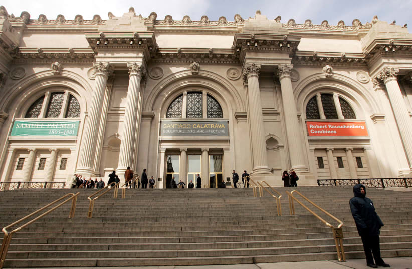 Visitors walk along steps of Metropolitan Museum of Art in New York (photo credit: KEITH BEDFORD/REUTERS)