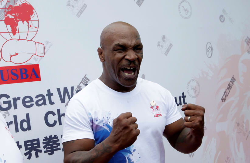 Former boxer Mike Tyson reacts as he speaks to the media, before the weigh-in of International Boxing Federation (IBF) World Championship Bout at the Mutianyu section of the Great Wall of China, on the outskirts of Beijing, China, May 24, 2016 (photo credit: JASON LEE / REUTERS)
