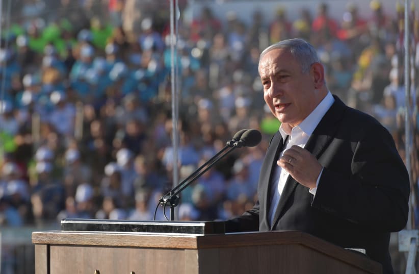Prime Minister Benjamin Netanyahu speaks during the graduation ceremony of the Israeli Air Force's newest pilots, June 2019 (photo credit: KOBI GIDEON/GPO)
