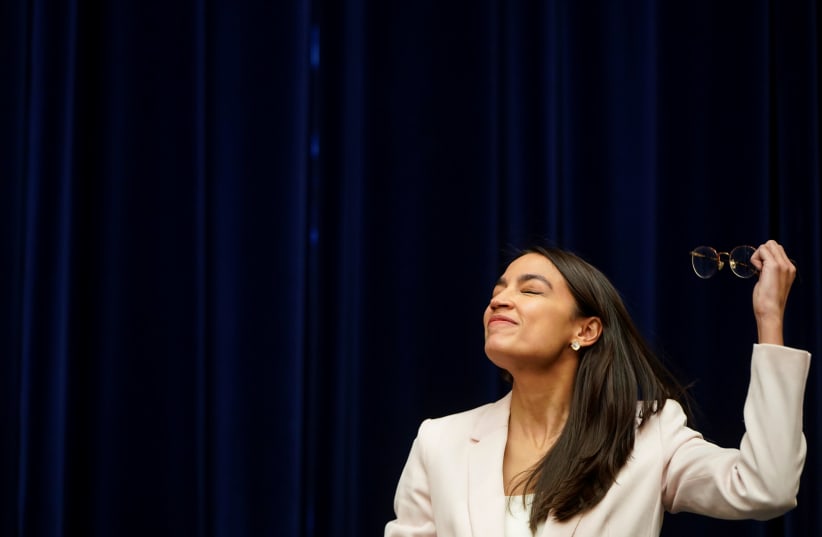 Rep. Alexandria Ocasio-Cortez (D-NY) removes her glasses before a hearing of the Civil Rights and Civil Liberties Subcommittee, May 15, 2019 (photo credit: JOSHUA ROBERTS / REUTERS)