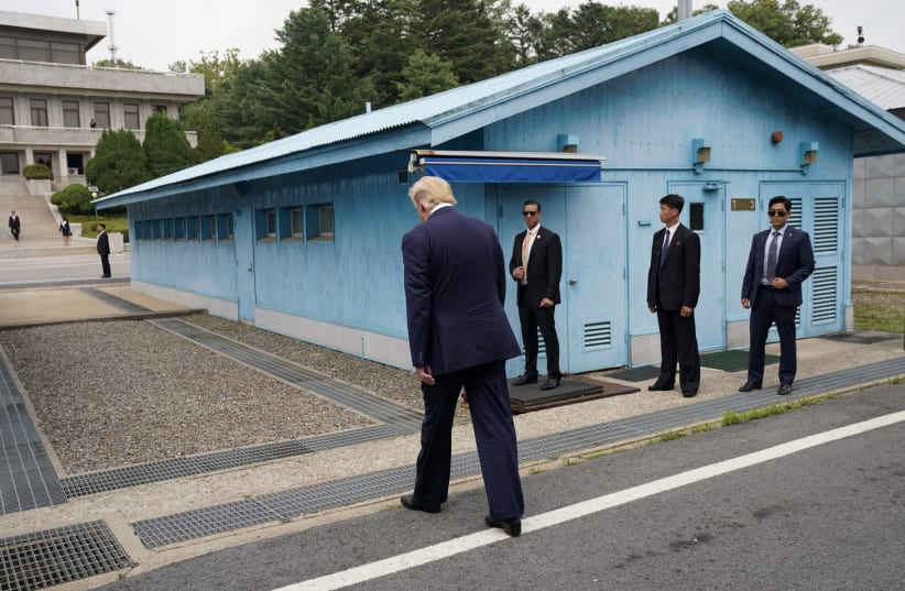 US President Donald Trump walks toward the North Korean border to meet with its leader Kim Jong Un at the demilitarized zone separating the two Koreas (photo credit: KEVIN LAMARQUE/REUTERS)