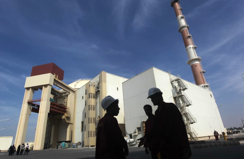 Iranian workers stand in front of Bushehr nuclear power plant, 1,200 km south of Tehran (photo credit: MEHR NEWS AGENCY/MAJID ASGARIPOUR/REUTERS)