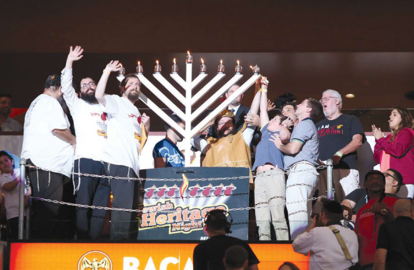 JOYOUS HANUKKAH: Lighting the menorah at Miami’s Rok Family Shul – Chabad Downtown Jewish Center. (photo credit: ROK FAMILY SHUL)