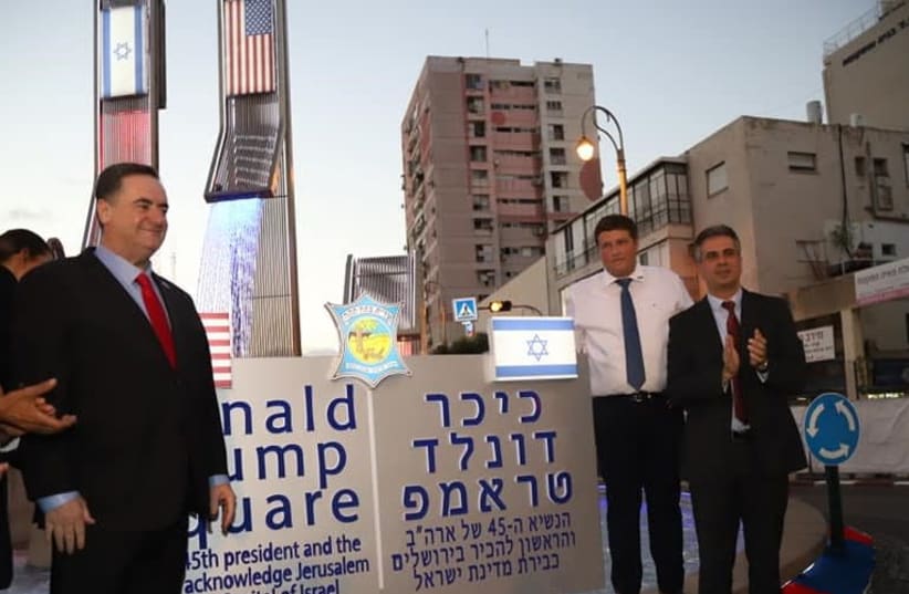 Foreign Minister Yisrael Katz [L] standing next to the sign of Trump Square in Petah Tikva   (photo credit: PETAH TIKVA MUNICIPALITY)