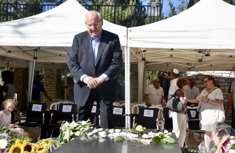 Israel's president Reuven Rivlin stands by his wife Nechama's grave on Mount Herzl   (photo credit: Mark Neiman/GPO)