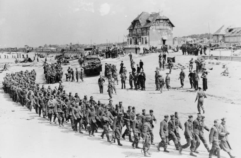 German POWs marching along Juno Beach landing area at Bernieres Sur Mer (photo credit: REUTERS/KEN BELL/NATIONAL ARCHIVES OF CANADA)