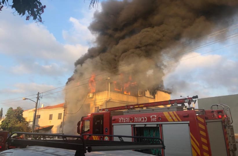The house of Carmel Mauda burning (photo credit: POLICE SPOKESPERSON'S UNIT)