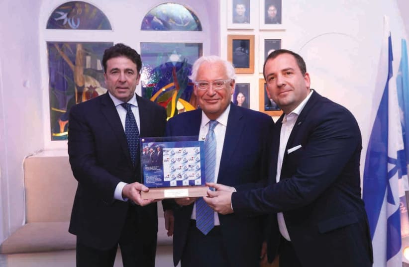 US AMBASSADOR to Israel David Friedman (center) and Director of Israel Philatelic Service Elhanan Shapira (right) unveil special edition US-Israel bond stamps at FOZ ceremony.  (photo credit: YOSSI ZAMIR)