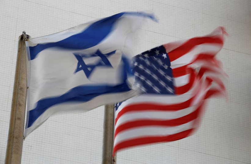 The American and the Israeli national flags can be seen outside the U.S Embassy in Tel Aviv (photo credit: AMIR COHEN/REUTERS)
