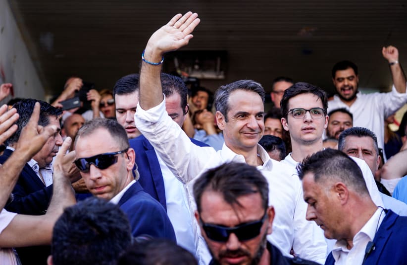 New Democracy conservative party leader Kyriakos Mitsotakis waves at supporters after voting at a polling station, during the general election in Athens, Greece, July 7, 2019. (photo credit: REUTERS)