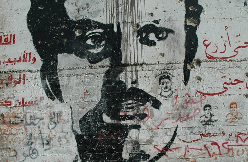 A graffiti image of PFLP terrorist Ghassan Kanafani on the security barrier in the West Bank (photo credit: WIKIMEDIA COMMONS/JUSTIN MCINTOSH)
