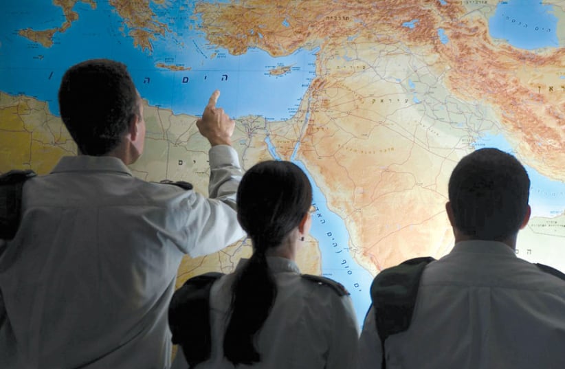 IDF OFFICERS examine a map of the Middle East. (photo credit: IDF SPOKESPERSON'S UNIT)