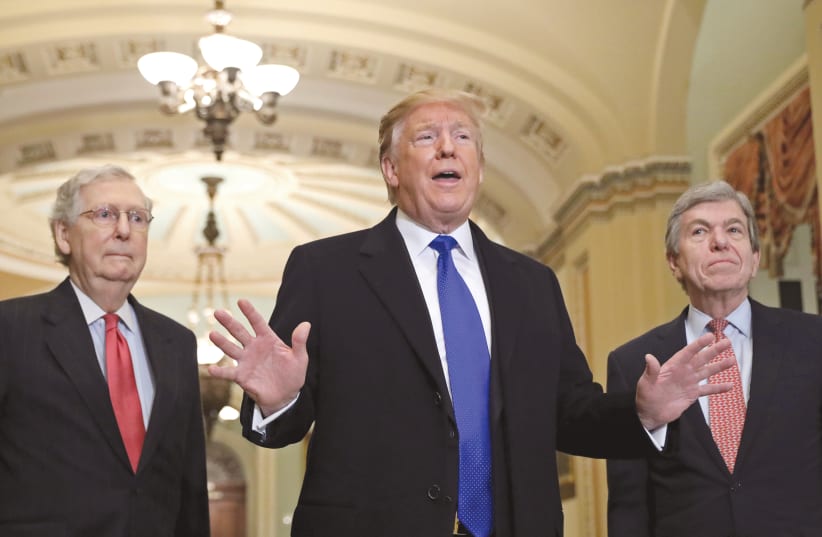 US President Donald Trump [C] Senate Makority Leader Mitch McConnell [L] and Missouri Sen Roy Blunt [R]  (photo credit: BRENDAN MCDERMID/REUTERS)