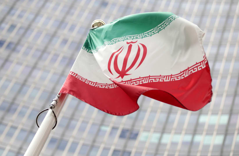 The Iranian flag flutters in front the International Atomic Energy Agency headquarters in Vienna (photo credit: REUTERS/LISI NIESNER)