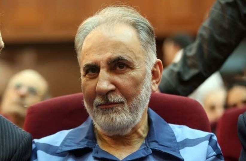 Former Tehran mayor Mohammad Ali Najafi, accused of shooting his second wife, reacts during his trial at Iran's criminal court on July 13, 2019. The high-profile trial opened today of a former Tehran mayor charged with murdering his wife, Iranian media reported. The charge sheet read out in court in (photo credit: AFP PHOTO)
