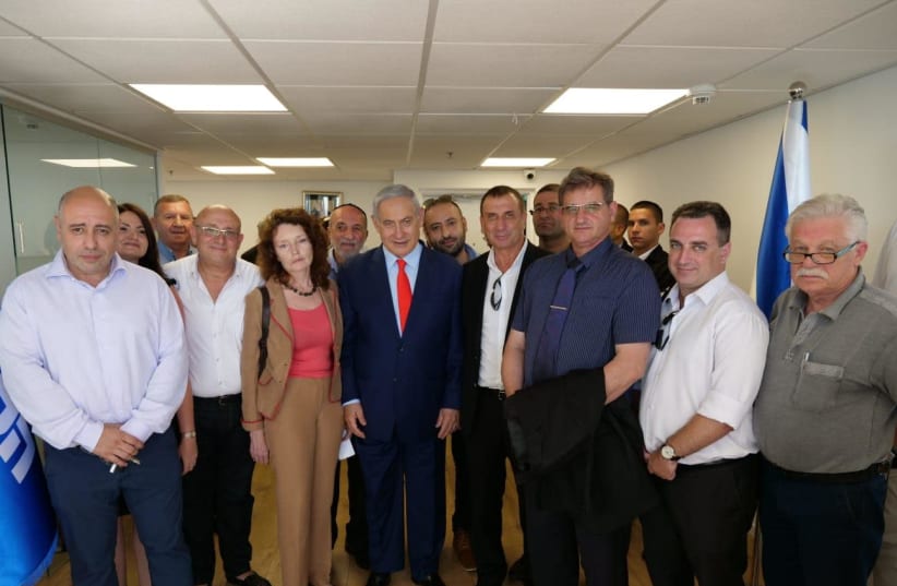 Prime Minister Benjamin Netanyahu hosts Yisrael Beytenu members who shifted to Likud July, 2019 (photo credit: LIKUD)