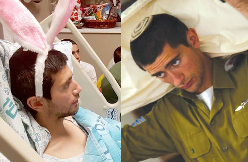 ON FEBRUARY 17, 2018, as a soldier in the IDF’s elite Yahalom unit, Emmanuel Zerah removed a Palestinian flag stuck in a fence – and the flag exploded in his left hand. Zerah – pictured below in his hospital bed, listening to the megillah on Purim – has since undergone eight operations. (photo credit: Courtesy)