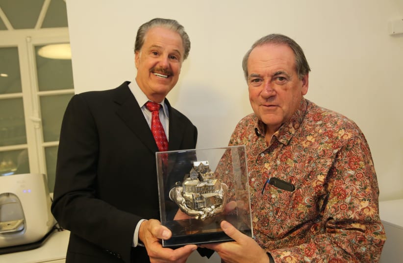 FOZ founder Dr. Mike Evans awards former Arkansas Governor Mike Huckabee with the Friends of Zion award this week in Jerusalem (photo credit: YOSSI ZAMIR)