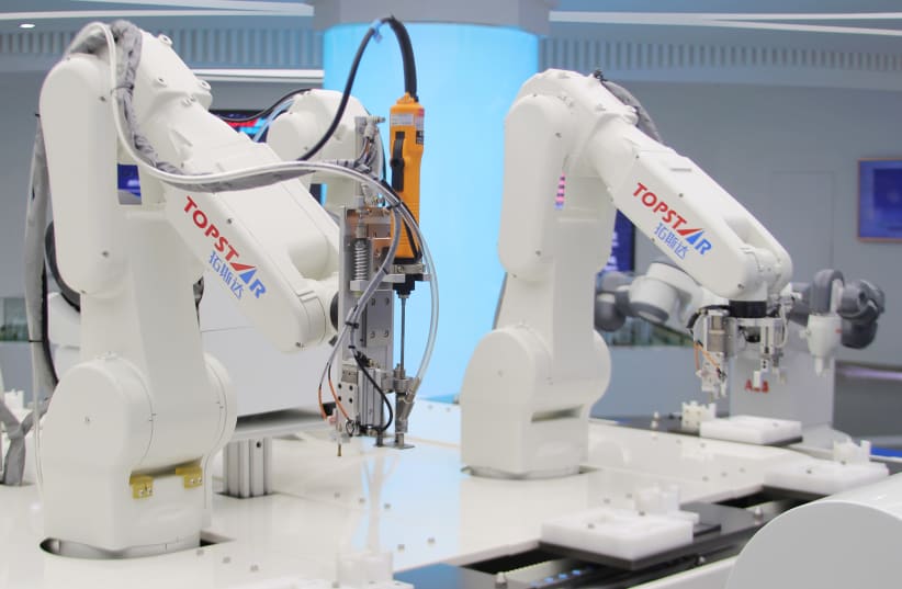 Industrial robots are pictured at a factory of Topstar Technology during a government-organised tour to the Guangdong-Hong Kong-Macao Greater Bay Area, in Dongguan (photo credit: REUTERS)