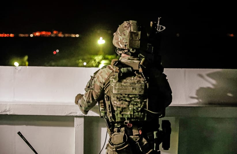 A British soldier looks on during an operation involving the oil supertanker Grace 1, that's on suspicion of carrying Iranian crude oil to Syria, in waters off the British overseas territory of Gibraltar (photo credit: REUTERS)