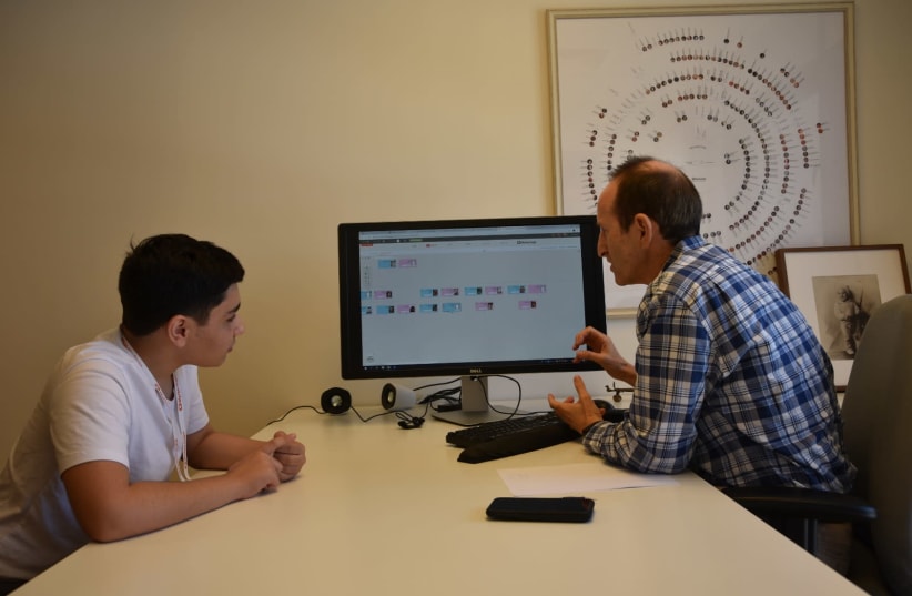 Gilad Japhet gives Jonathan Cohen some research tips at the MyHeritage office in Bnei Atarot. (photo credit: MYHERITAGE)
