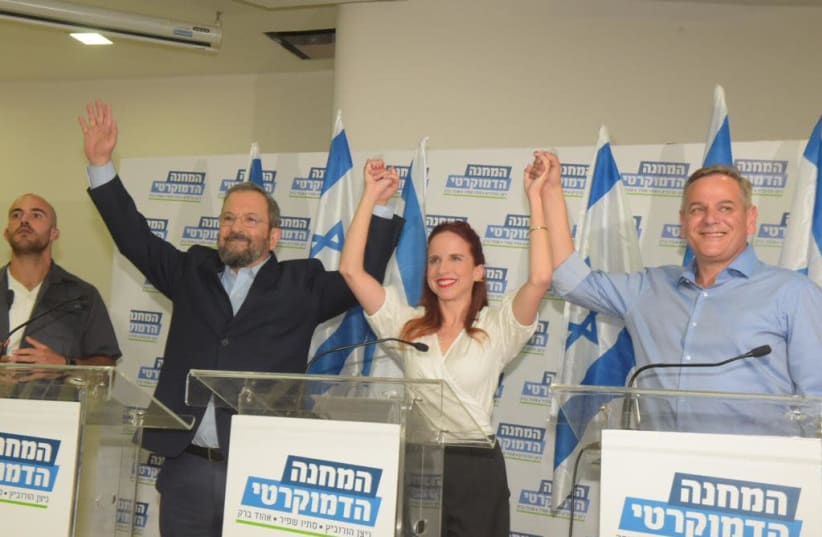 Former prime minister Ehud Barak [L] Labor MK Stav Shaffir [C] and Meretz leader Nitzan Horowitz [R] hold hands to announce their merge during a Thursday press conference   (photo credit: AVSHALOM SASSONI)