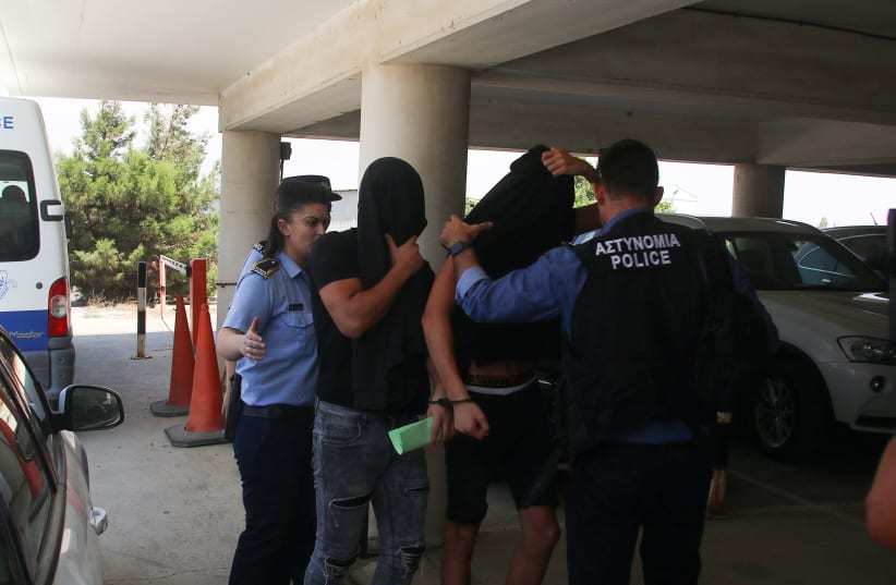 Israeli tourists, arrested over the alleged rape of a British tourist in the resort town of Ayia Napa, arrive to appear before a magistrate for a remand hearing in the Famagusta courthouse in Paralimni, Cyprus (photo credit: REUTERS/YIANNIS KOURTOGLOU)