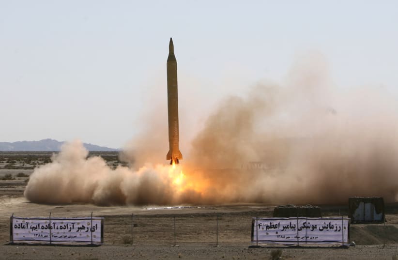 A Ghadr 1 class Shahab 3 long range missile is prepared for launch during a test from an unknown location in central Iran (photo credit: REUTERS)