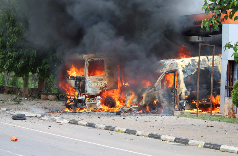An ambulance and a fire engine set on fire by a Shi'ite group are seen at the Federal Secretariat in Abuja, Nigeria July 22, 2019 (photo credit: AFOLABI SOTUNDE/REUTERS)