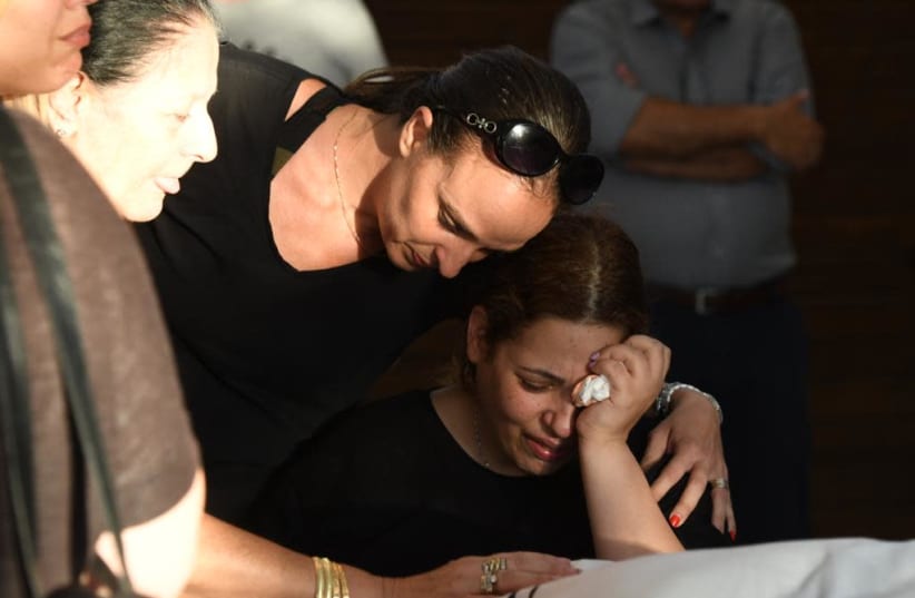 Dikla Hisdai, the widow of Ofir Hisdai, her husband was shot down in an argument over parking space. The funeral was on Monday in Ramle.   (photo credit: AVSHALOM SASSONI/ MAARIV)