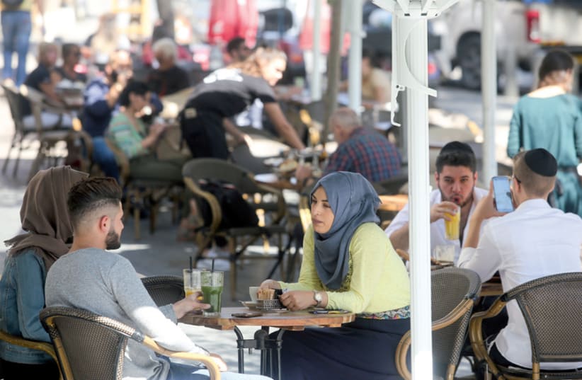 Arab Israelis and Haredi youth at a café in Jerusalem (photo credit: MARC ISRAEL SELLEM)