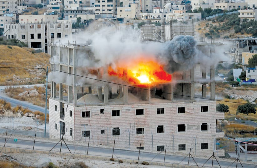 A BUILDING IS blown up by Israeli forces in the village of Sur Bahir last week (photo credit: REUTERS/MUSSA QAWASMA)