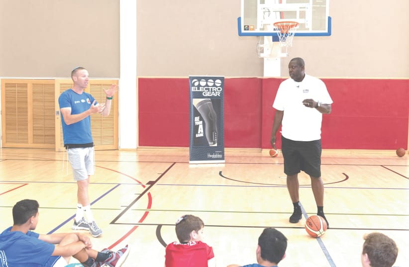 ED PINCKNEY (right) and Tamir Goodman (leftt) coach young Israeli basketball players during Goodman’s camp last month at the Jerusalem YMCA (photo credit: YEHOSHUA HALEVI)