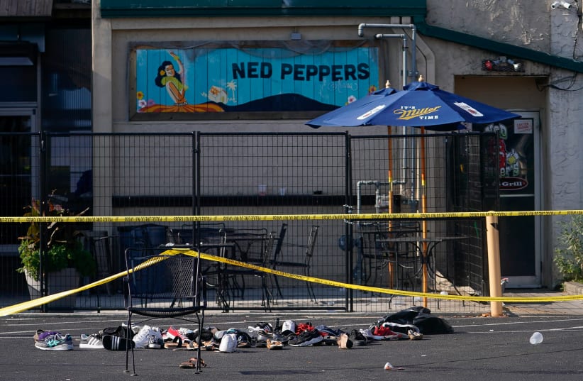 Shoes are piled in the rear of Ned Peppers Bar at the scene after a mass shooting in Dayton (photo credit: BRYAN WOOLSTON/REUTERS)