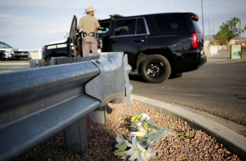 Flowers are seen at the site of a mass shooting where 20 people lost their lives at a Walmart in El Paso, Texas, U.S. August 4, 2019 (photo credit: REUTERS/JOSE LUIS GONZALEZ)
