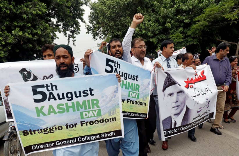 Demonstrators hold signs and chant slogans as they march in solidarity with the people of Kashmir, during a rally in Karachi (photo credit: REUTERS)