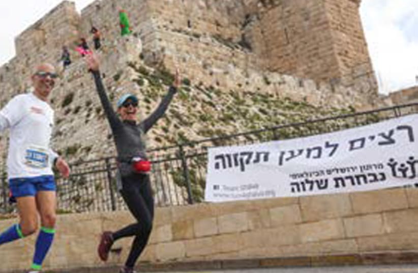 ‘BUT IN the here and now, where I live, Yerushalayim is a city of splendor, full of life’: Runners take part in the Jerusalem Marathon this past March. (photo credit: MARC ISRAEL SELLEM)