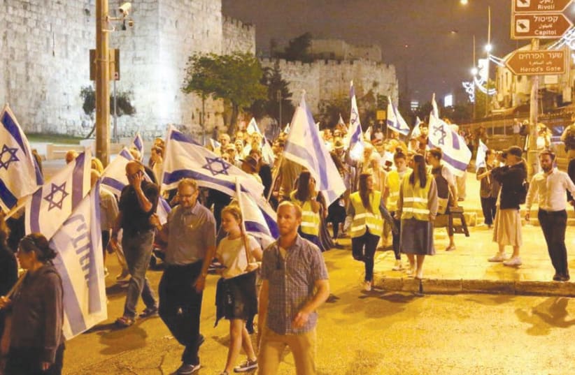 MARCHING AROUND the Old City walls as part of the annual Tisha Be’Av Walk. (photo credit: GERSHON ELINSON)
