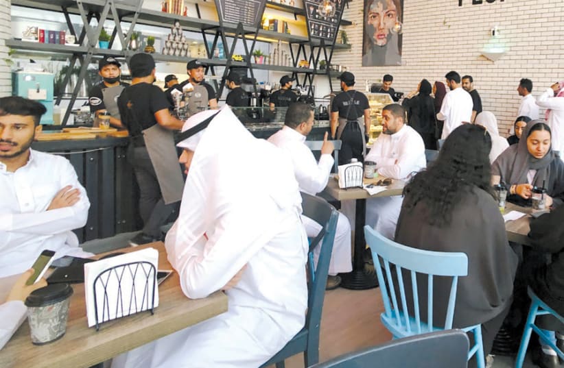WOMEN SIT among men in a newly opened cafe in Khobar, Saudi Arabia, on August 2. (photo credit: HAMAD I MOHAMMED/REUTERS)
