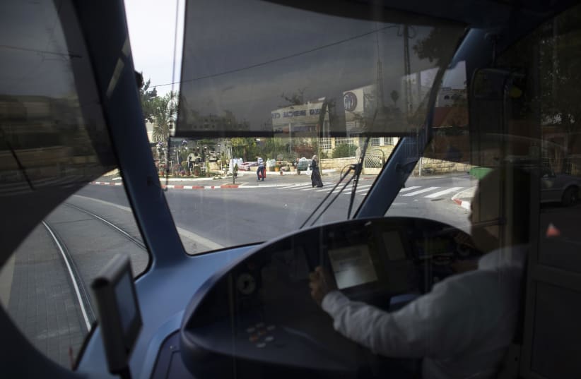 A light railway driver drives a tram in Jerusalem (photo credit: REUTERS/Ronen Zvulun)