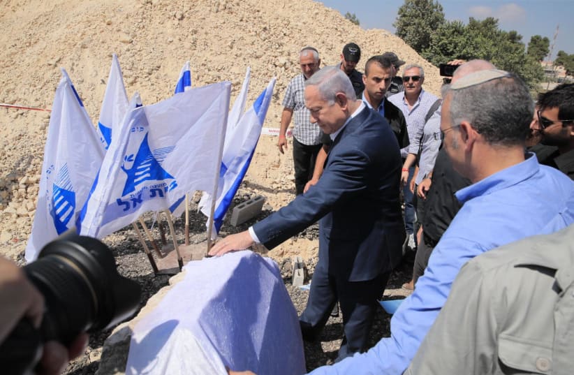 Prime Minister Benjamin Netanyahu visits the Beit El settlement hours after the body of terror victim Dvir Sorek, 19, was found. (photo credit: SHARON REVIVO)