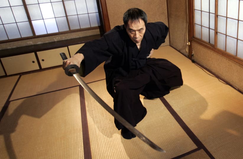 Japanese ancient martial arts master Yoshinori Kouno demonstrates his skills in Tokyo February 14, 2008. The 59-year-old master of Japanese ancient martial arts may never get a chance to test his skills in real combat in the modern world, but some of the country's top athletes are learning from his  (photo credit: YURIKO NAKAO/ REUTERS)