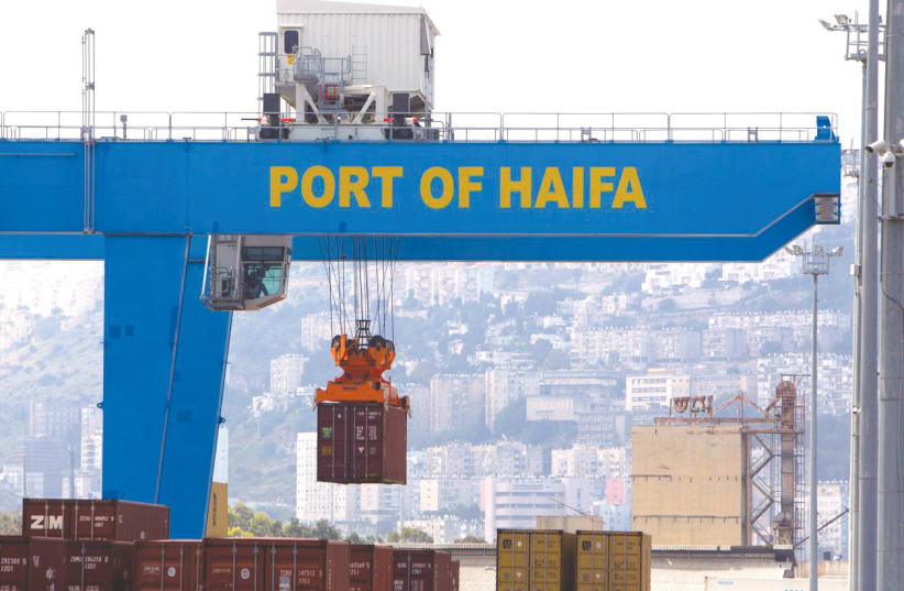A CRANE unloads a container at the Port of Haifa (photo credit: REUTERS/Ronen Zvulun)